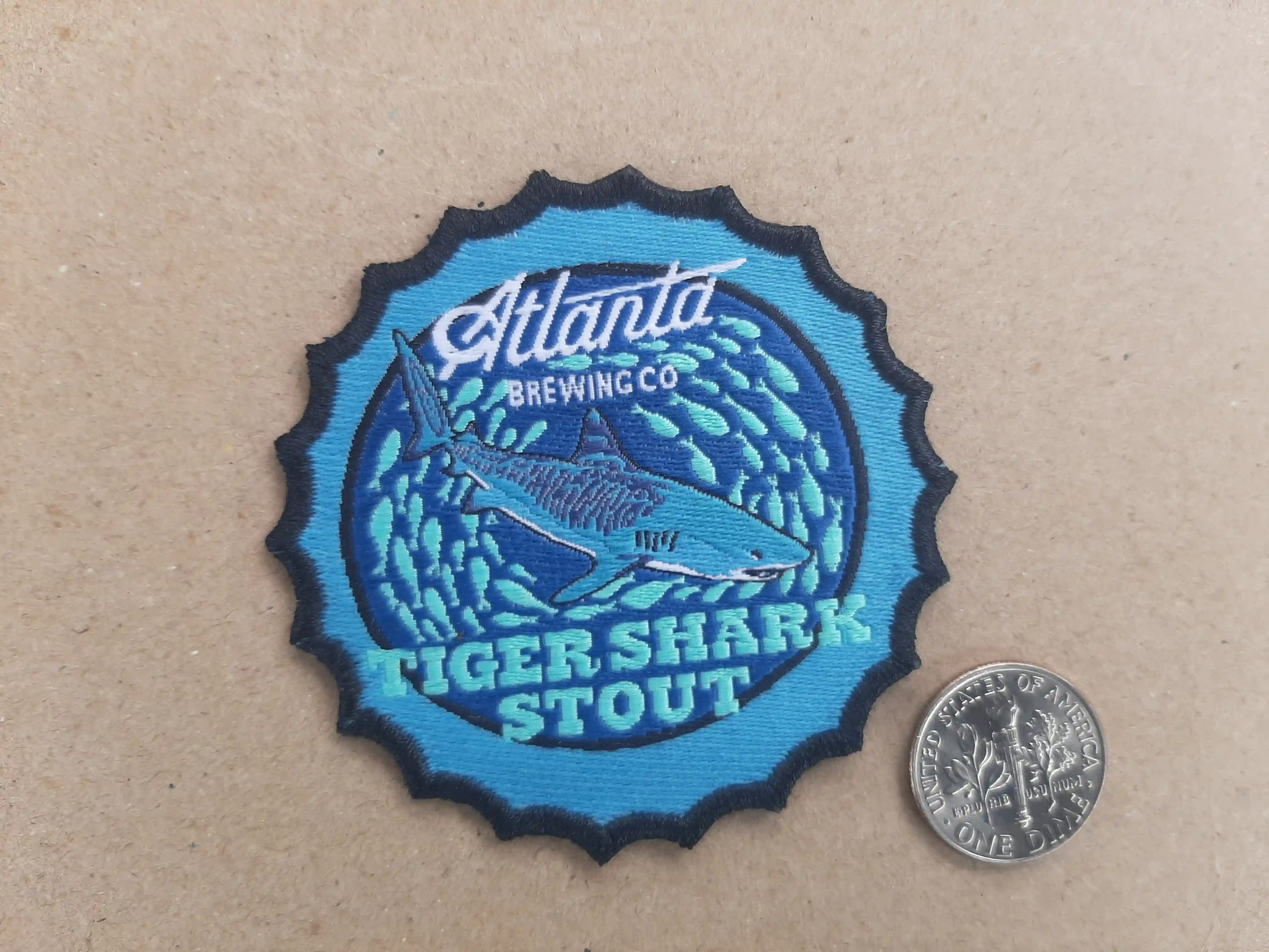 Bottle Cap shaped woven patches are unique and stylish.  Restaurants love the patch style and are unique and eye catching for your brand merch Atlanta Brewing Co Restaurant_Brewery